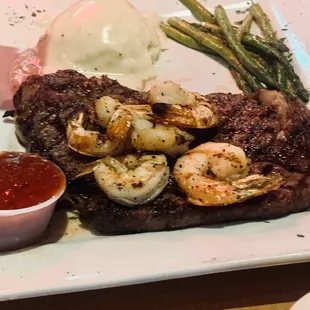 Texas Ribeye (medium-well) with mashed potatoes asparagus and added grilled Shrimp