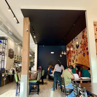 people sitting at tables in a restaurant