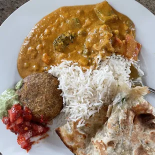 Potato patty, garlic naan, and some kind of curry.