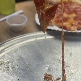 The perfect cheese pull on my Peppino&apos;s pepperoni pizza