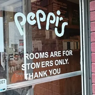 a woman standing in front of a store window
