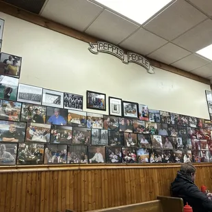 a wall full of photos of people