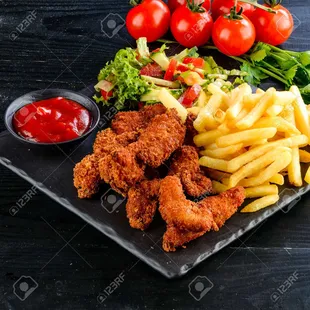 a plate of fried chicken, fries, tomatoes, lettuce and ketch