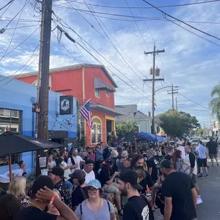 a crowd of people walking down the street