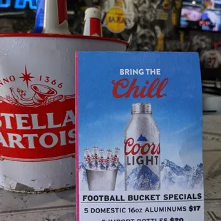 a menu and a bottle of chili