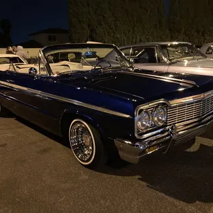 a classic car parked in a parking lot