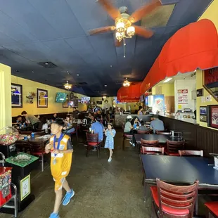 a kid running through the dining room