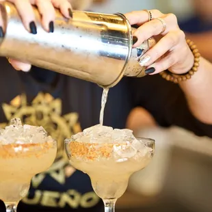 a woman pouring a cocktail