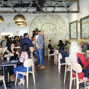 a large group of people eating in a restaurant