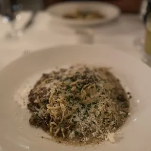 a plate of pasta with parmesan cheese