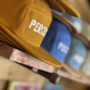 a variety of hats on a shelf
