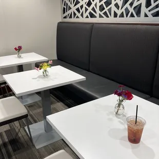 a view of a restaurant with tables and benches