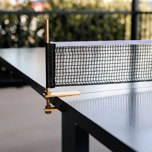 Custom black pigment concrete ping ping table with brass inlay -- Midtown, Oklahoma City