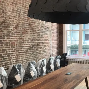 Conference room install with acoustic lighting and custom walnut table on Greene Street -- Soho, New York
