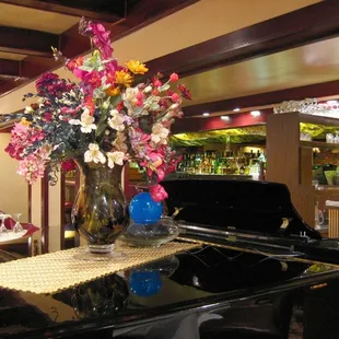 a piano and a vase of flowers
