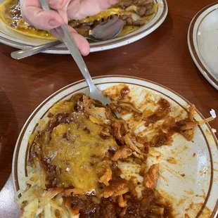 Hash browns with red chili and cheese on the side