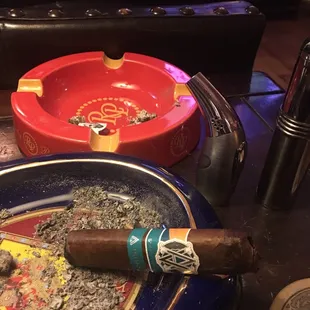 a cigar and ashtray