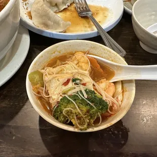 a bowl of soup with noodles and broccoli