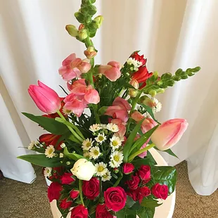 For any occasion! Vase arrangement featuring tulips, spray roses, and alstroemeria.