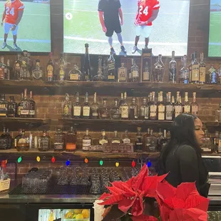 a man and a woman watching televisions in a sports bar