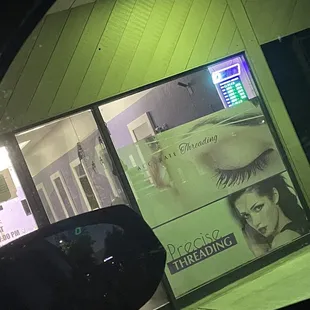 Entrance to threading establishment, she closes at 7 every day except Sunday when she's closed.