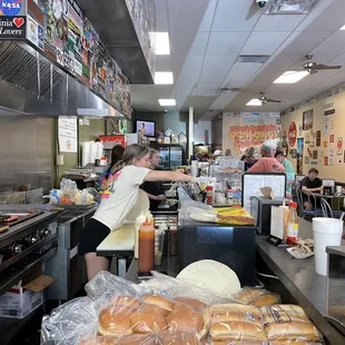 a woman preparing food in a restaurant kitchen