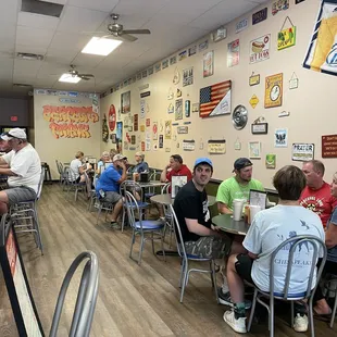 a group of people sitting at tables in a restaurant