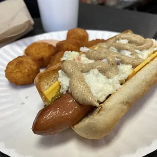 a hot dog on a paper plate
