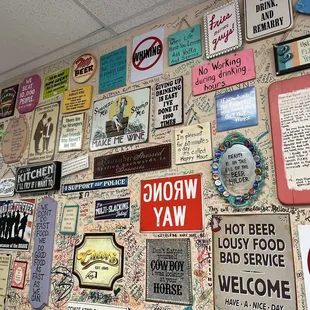 a wall full of various signs