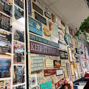 a wall full of signs in a restaurant