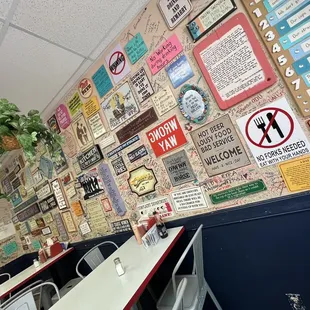 a restaurant with many signs on the wall