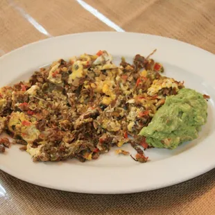 a plate of food with guacamole