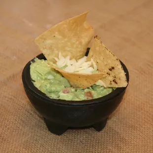 a bowl of guacamole and chips
