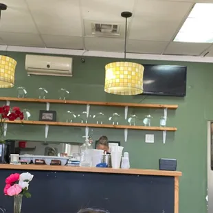 a little girl sitting at the counter