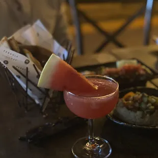 a glass of watermelon and a plate of food