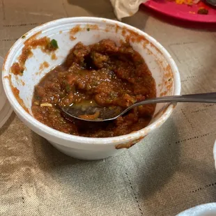 a bowl of chili with a spoon