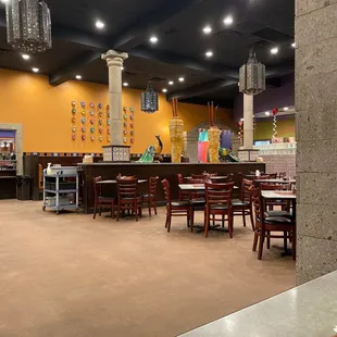 a dining area with tables and chairs