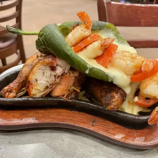 Pollo asado "Fuego Style": Jack cheese-stuffed poblano with Gulf shrimp and tomatoes on top