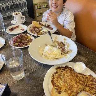 a boy eating breakfast at a restaurant