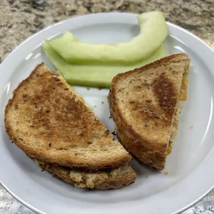 a grilled cheese sandwich and a cucumber