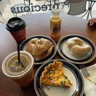 Iced lavender oat milk latte, slice of veggie quiche, plain bagel, VB sunrise coffee and everything bagel with bacon egg &amp; cheese