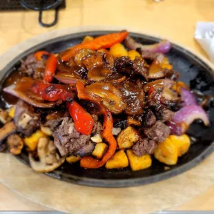 a plate of steak and vegetables