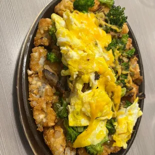 a skillet of eggs and broccoli