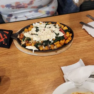 a pizza with cheese and spinach
