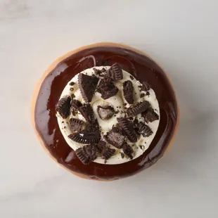 Cookies &amp; Crème Doughnut - Chocolate glazed doughnut with vanilla cream and crushed cookies.