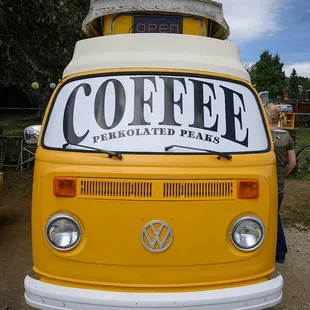 a yellow van with a coffee sign on top