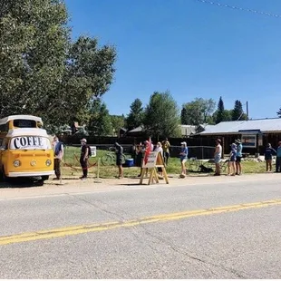 a group of people standing on the side of the road