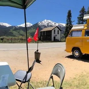 a yellow bus parked in a field