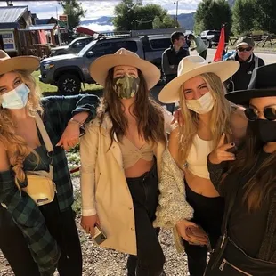 a group of women wearing masks
