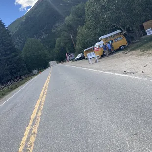 a line of food trucks parked on the side of the road